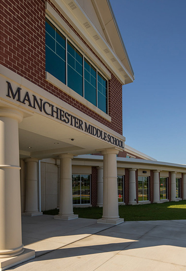 A thin brick precast concrete facade on the entrance of Manchester Middle School