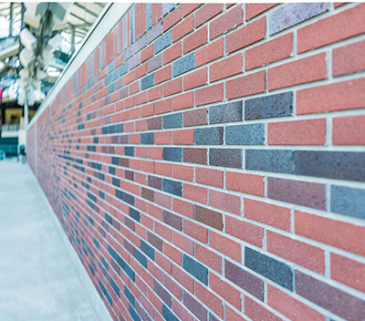 A thin brick facade that looks like a traditional red brick building.